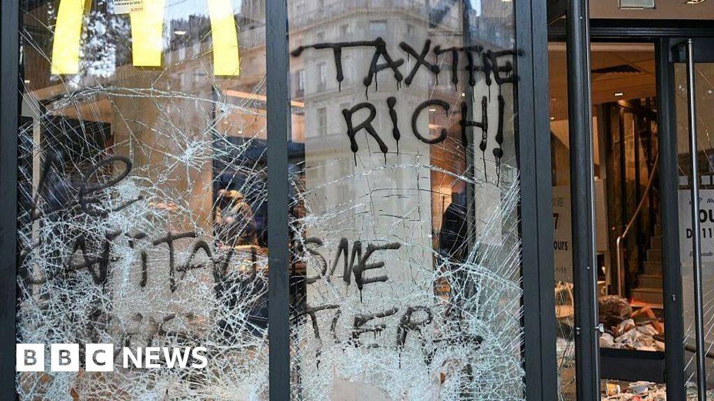 Burnt out cars and shattered glass on Paris streets after protests turn to riots and looting