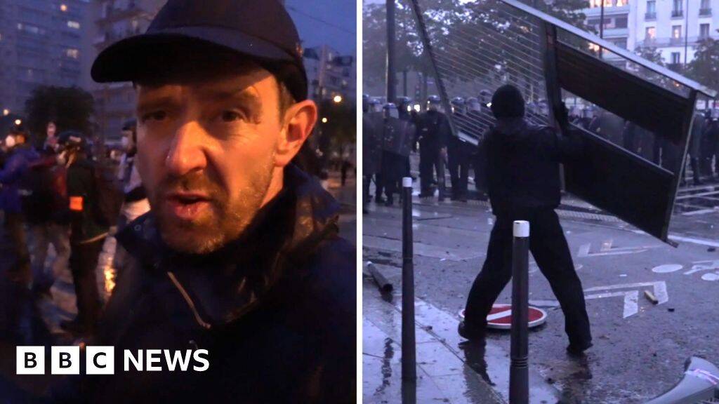 Fireworks and tear gas as protesters and riot police clash in Paris