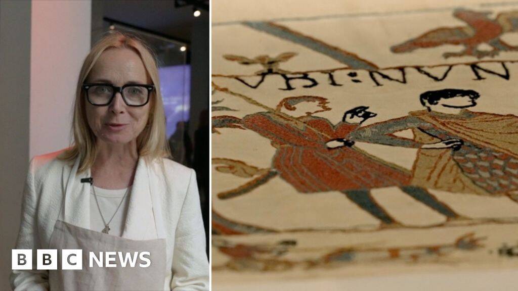 Donning protective kit for a first glance at the Bayeux Tapestry