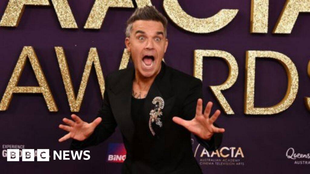 Watch moment Robbie Williams surprises 94-year-old fan